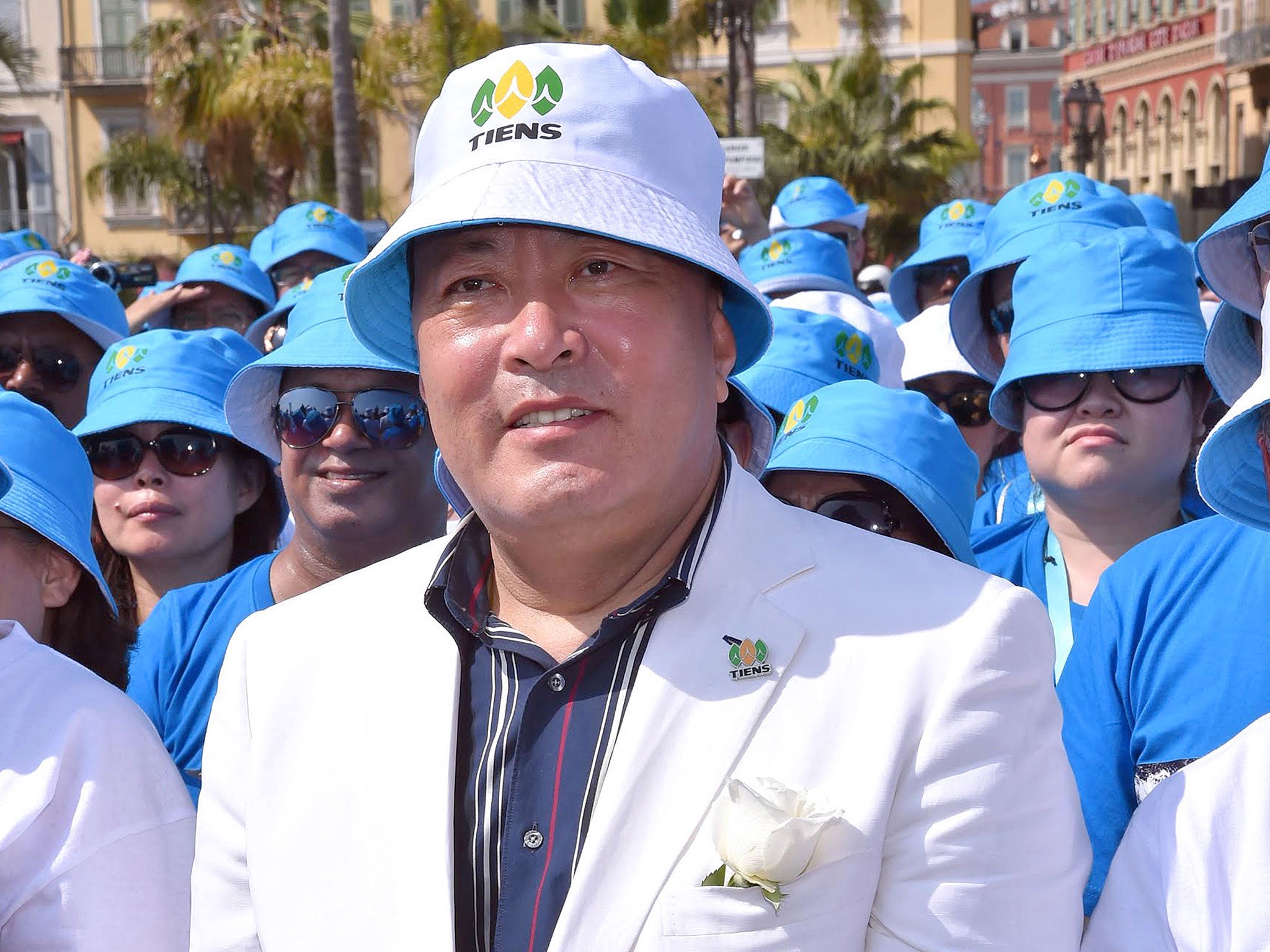 Li Jinyuan poses with staff members, during a parade on the Promenade des Anglais in Nice, southeastern France