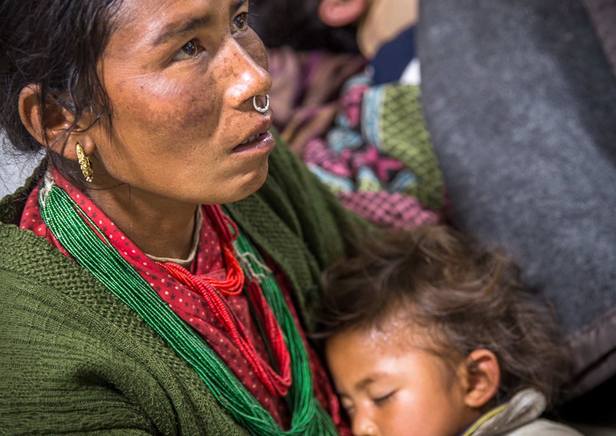A Nepalese woman cradles her child after Tuesday's earthquake