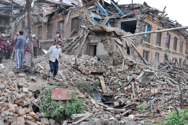 Rescue workers arrive at a collapsed building after Nepal's latest earthquake