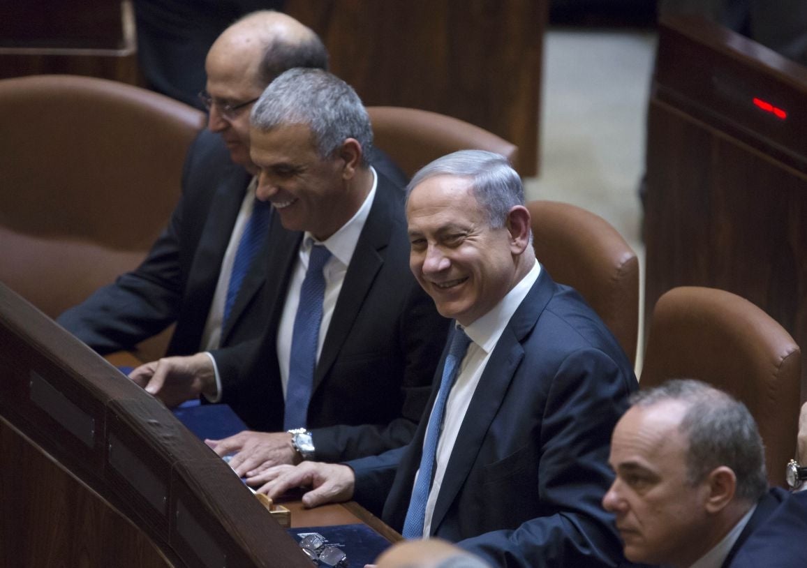 Israeli Prime Minister Benjamin Netanyahu, second right, heads the new government as ministers take their place