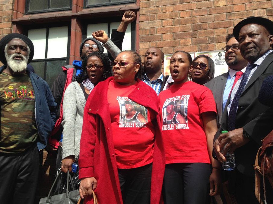 Supporters and family members of Kingsley Burrell stand outside Birmingham Coroner's Court