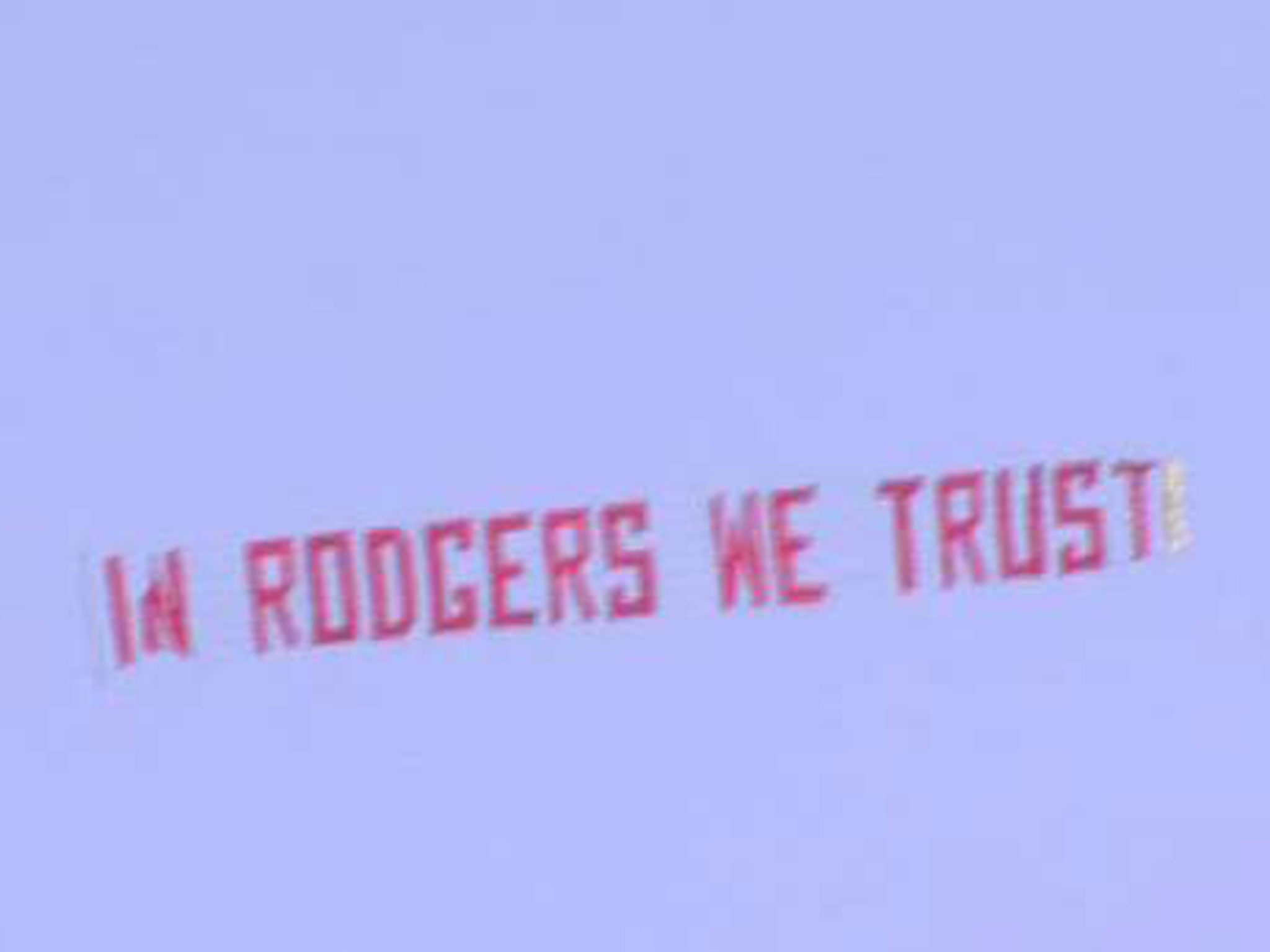 A banner appears over Anfield reading 'In Rodgers we trust'