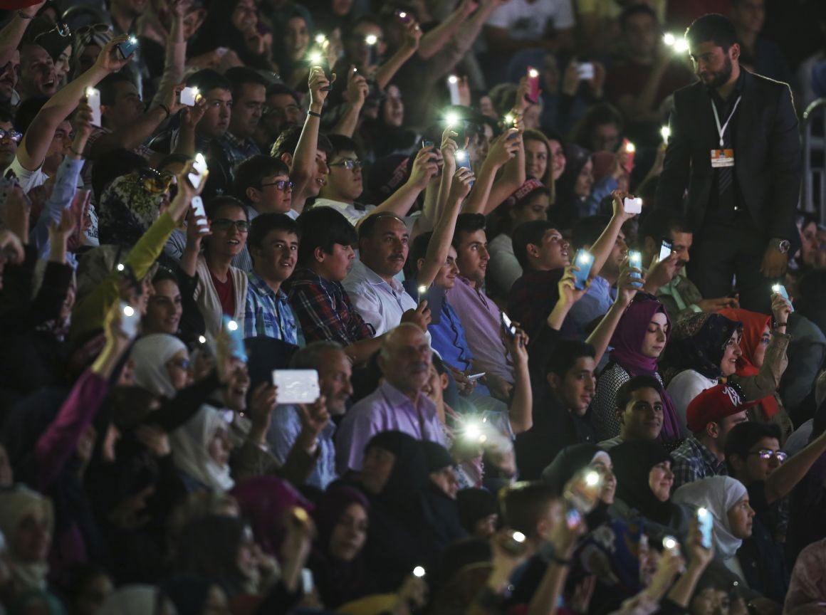 Students held up their phones as President Recep Tayyip Erdogan condemned the death sentences in Turkey