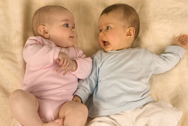 Two babies lying down together, model released