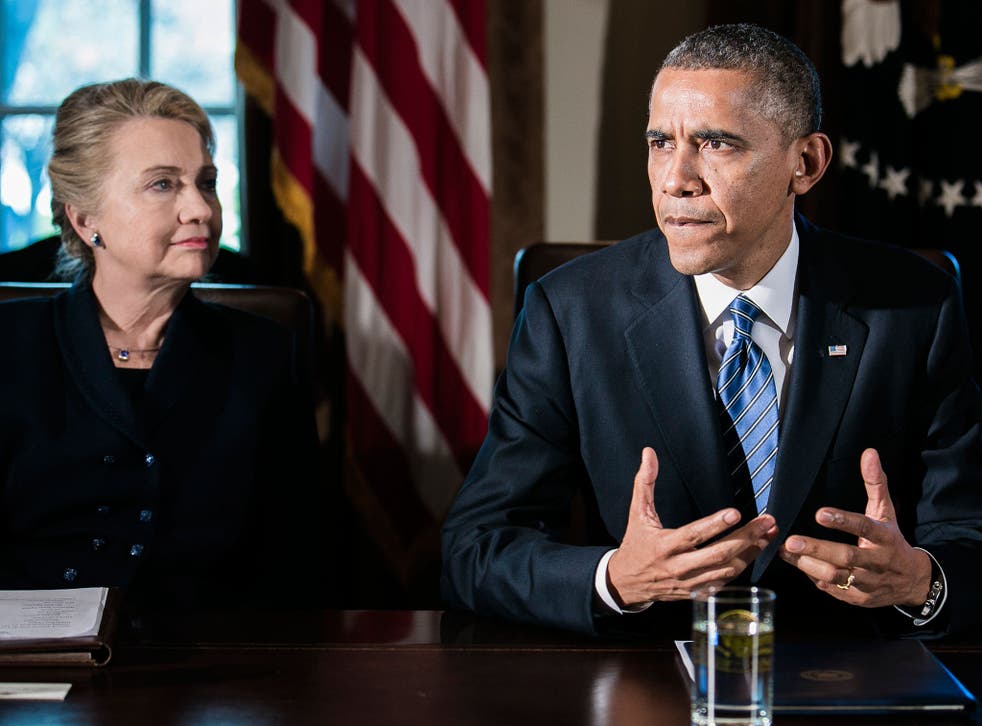 File: President Barack Obama (R) speaks as Secretary of State Hillary Clinton listens at a cabinet meeting at the White House on November 28, 2012