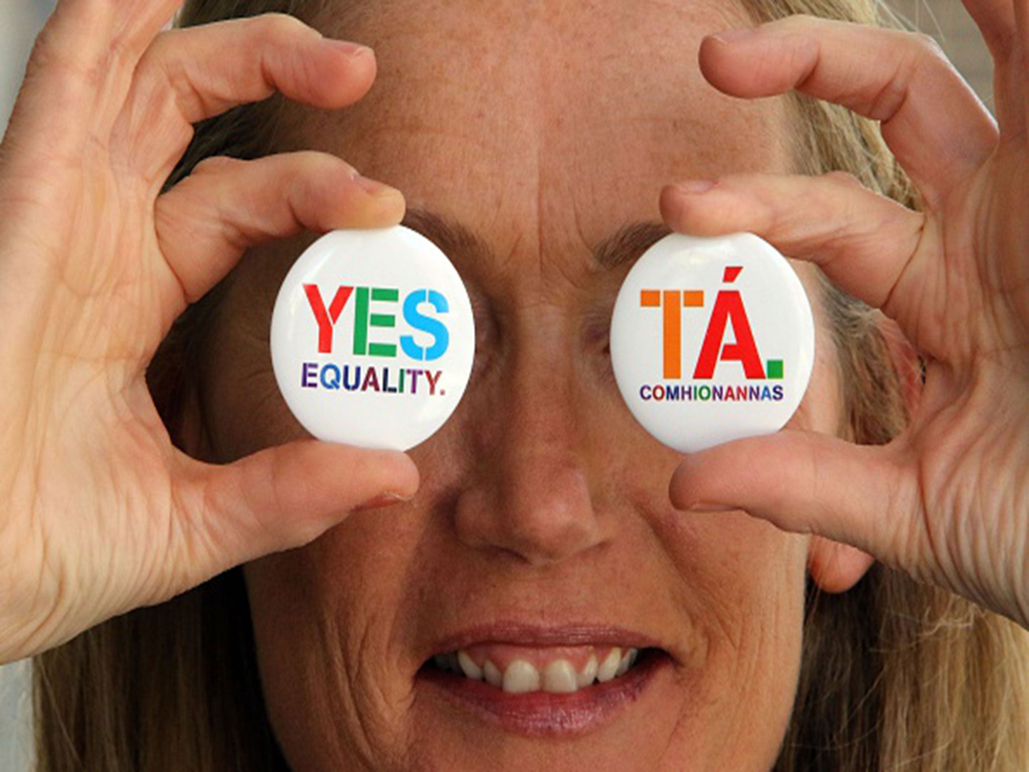 Pro-same-sex marriage campaigner Glenna Benson poses with yes badges at an event ahead of the Irish same-sex marriage referendum