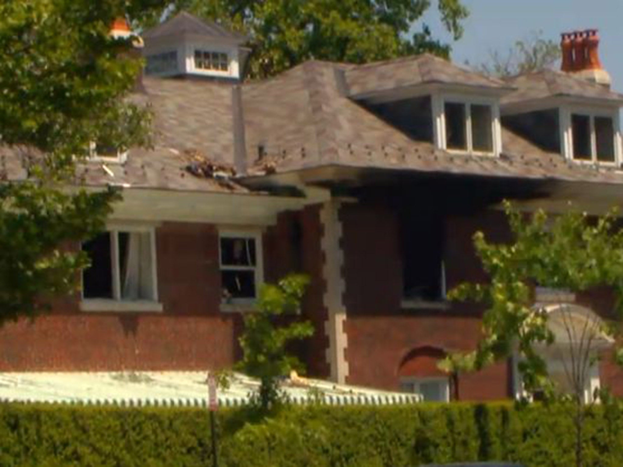 Fire damage can be seen to the roof of the Savopoulos home after the murder of three family members and their housekeeper (credit: ABC News)