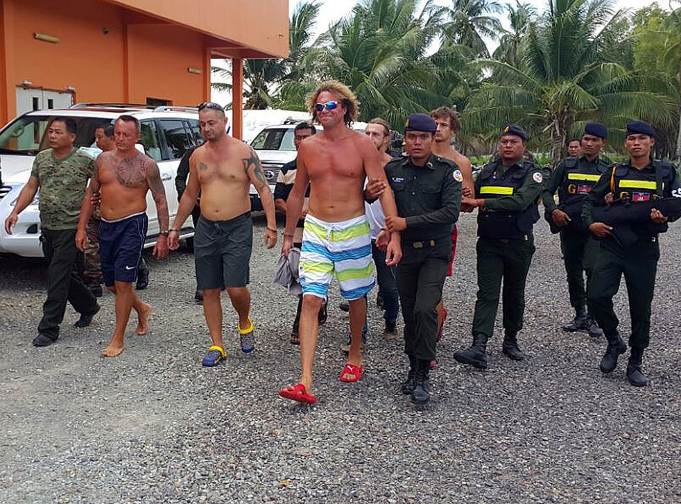 Sergei Polonsky, front, is arrested by Cambodian police