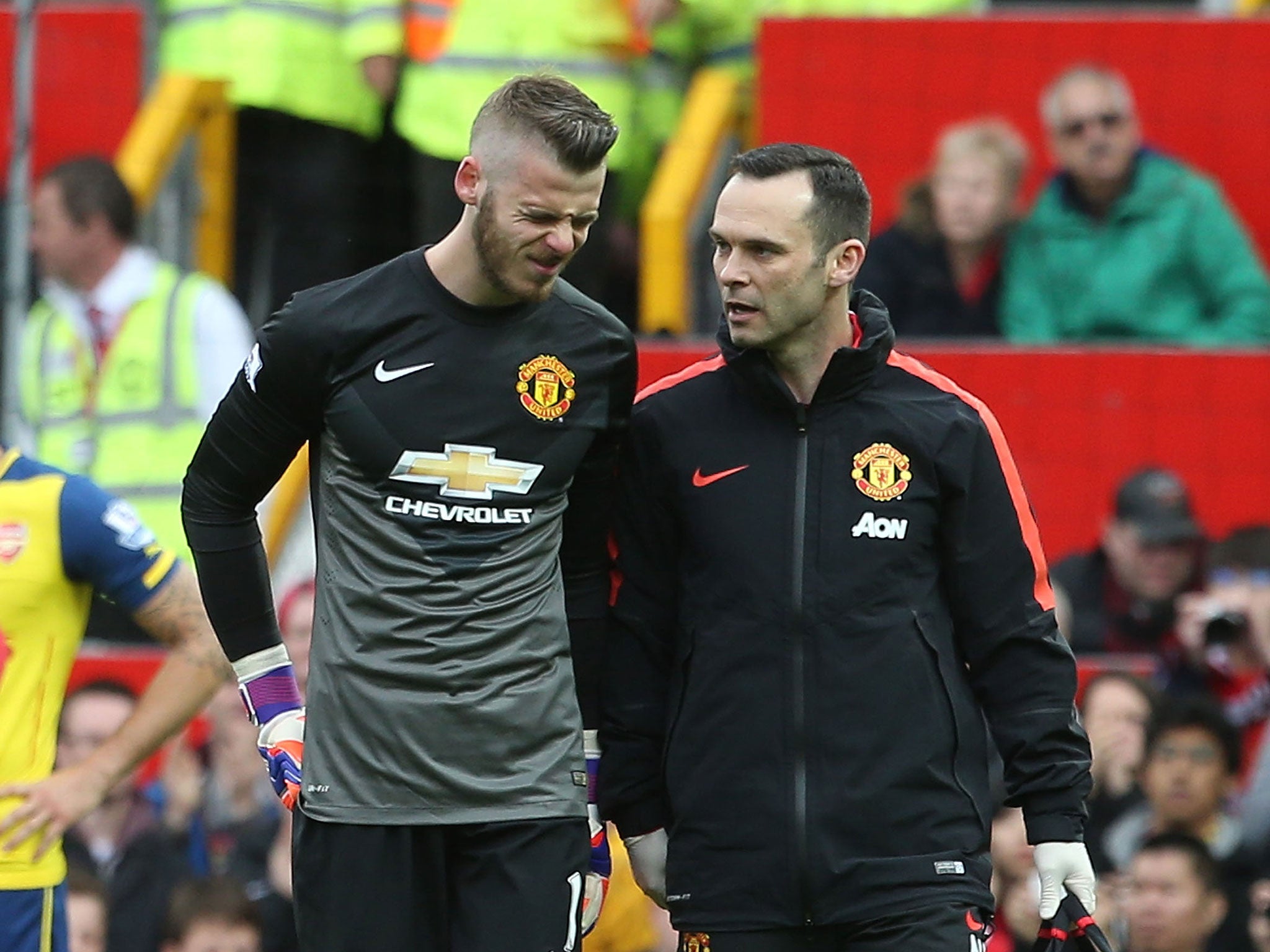 David De Gea, left, heads off the pitch after injuring a hamstring