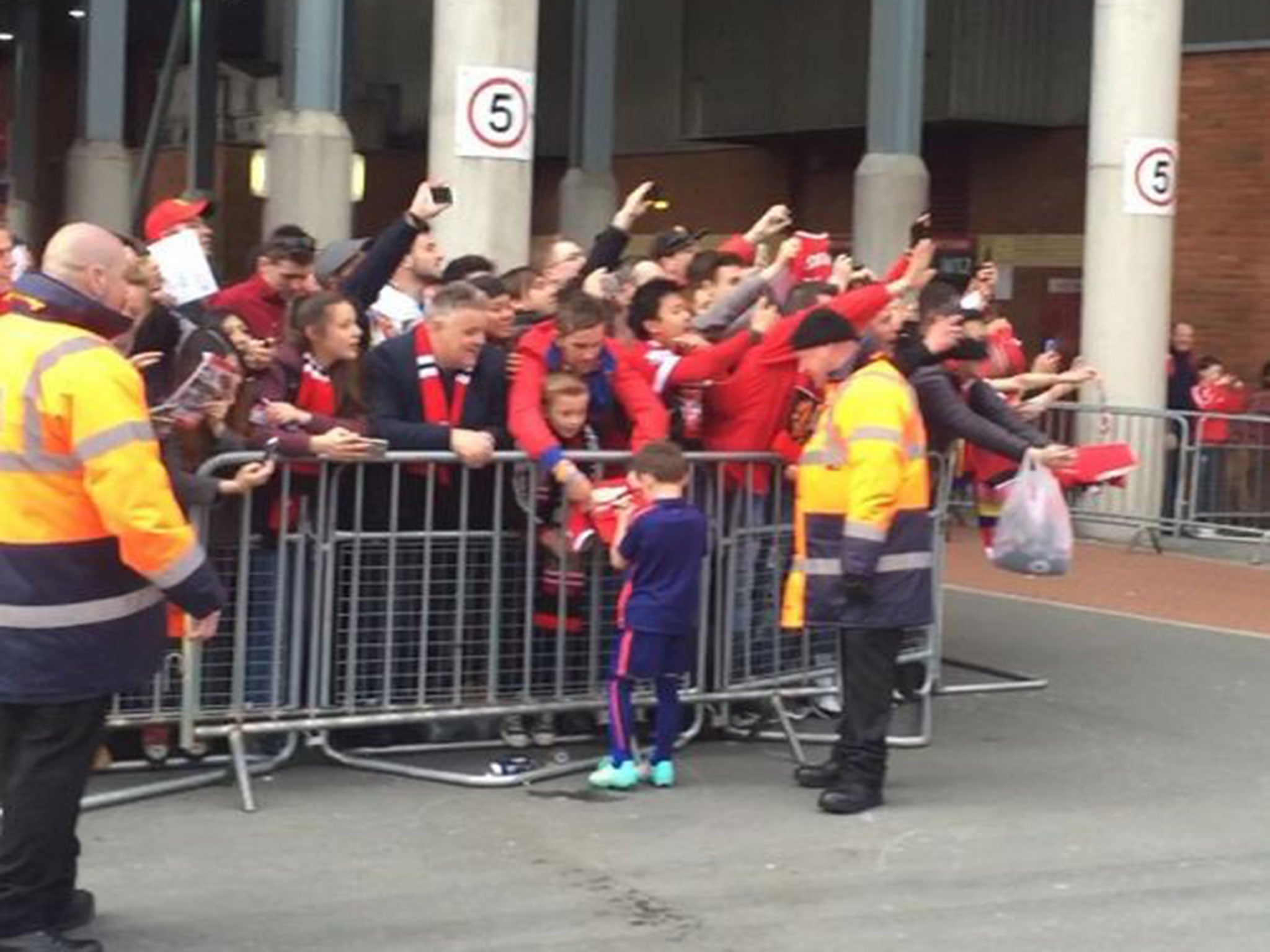 Kai Rooney signs autographs for Manchester United fans