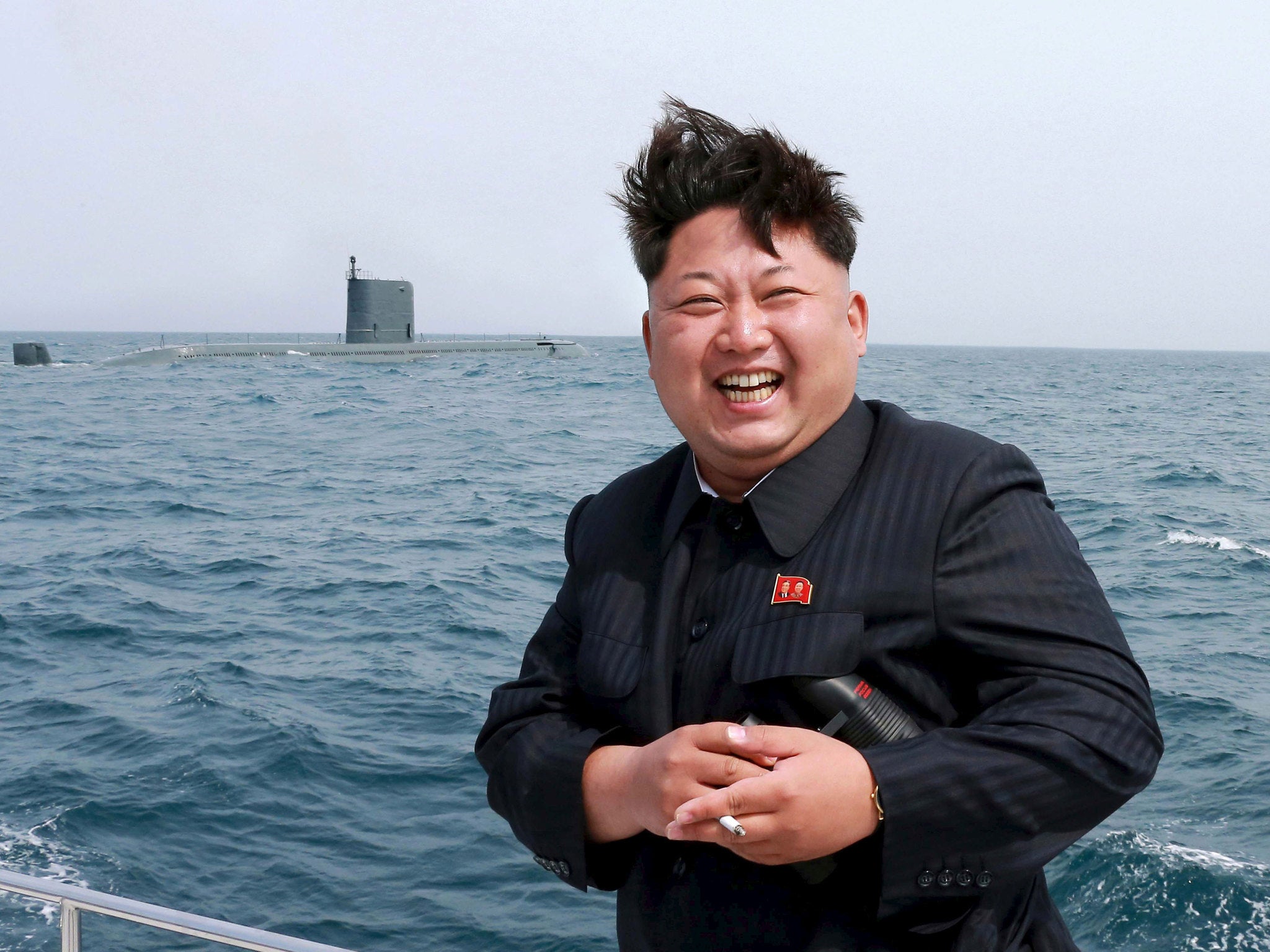 North Korean leader Kim Jong Un watches the test-fire of a strategic submarine underwater ballistic missile (not pictured), in this undated photo released by North Korea's Korean Central News Agency