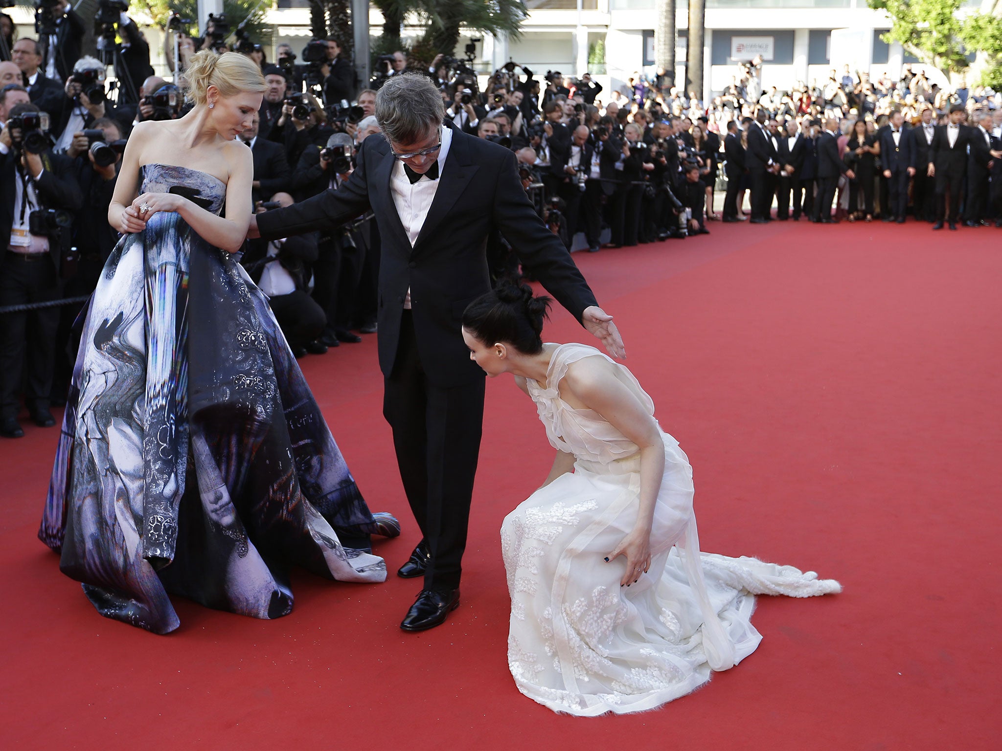 Cate Blanchett and director Todd Haynes turn to help Rooney Mara upon arrival for the screening of the film Carol at the Cannes Film Festival, 17 May 2015