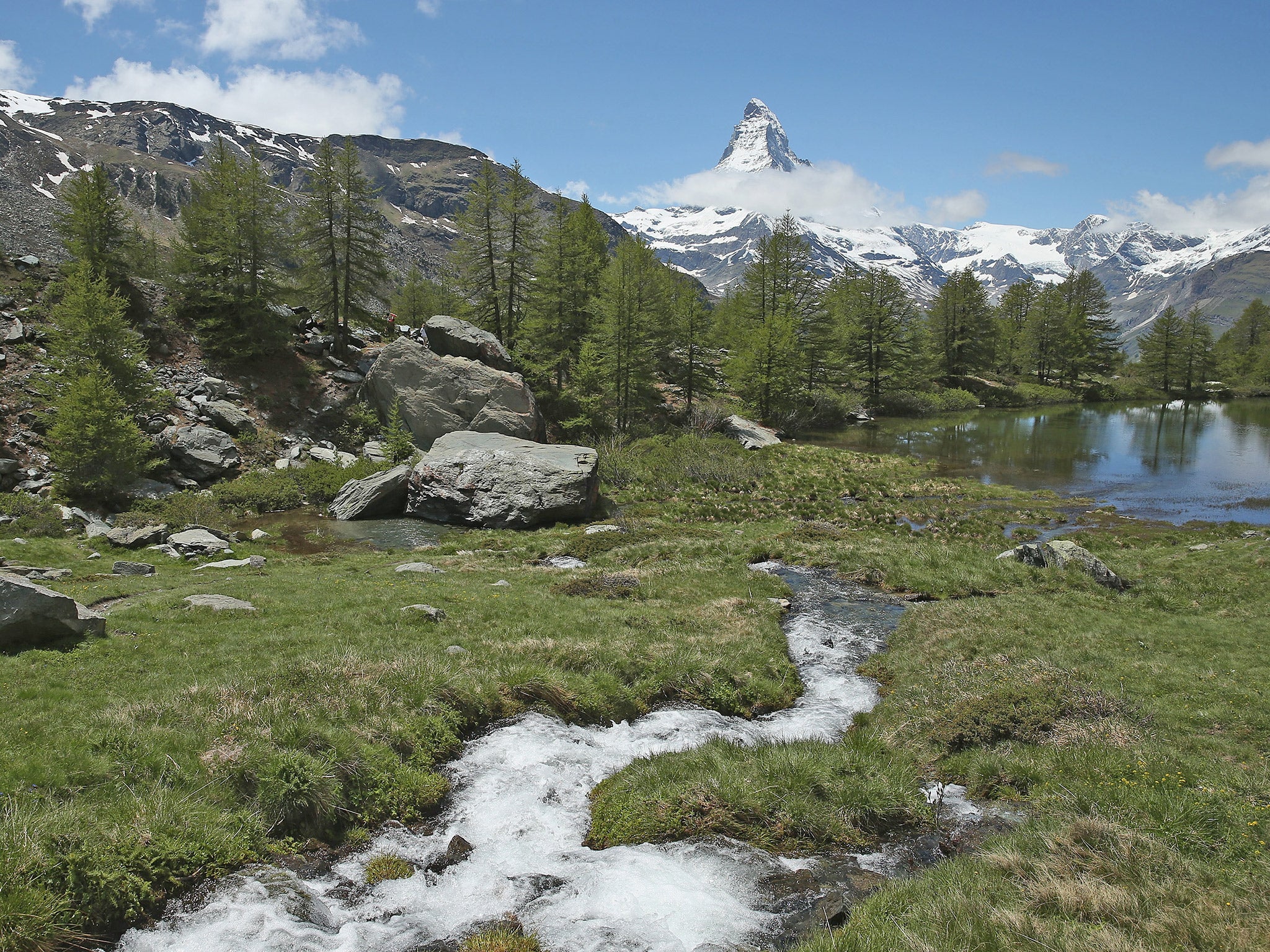 A small stream leads to a lake near the Matterhorn mountain in Switzerland