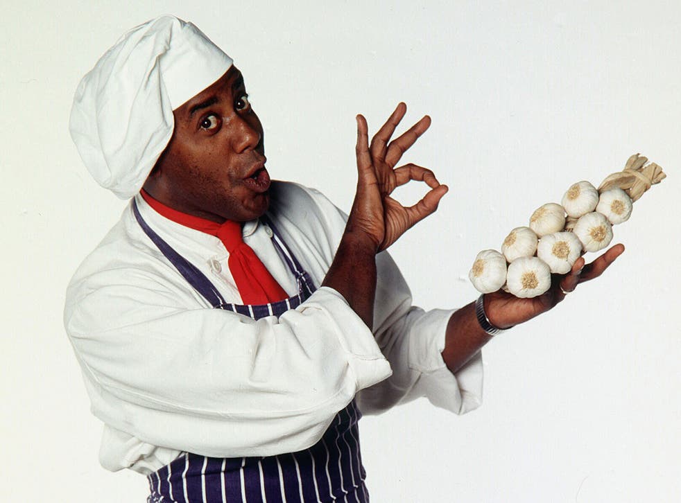 Ainsley Harriott as best remembered - in 1996, camping it up next to some vegetables