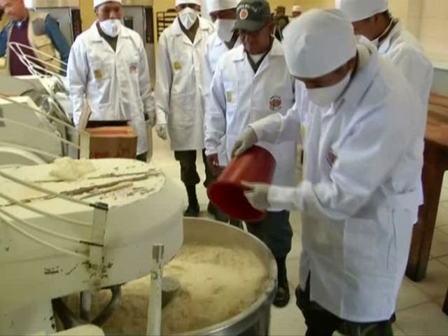 Soldiers prepare the dough for their bread rolls