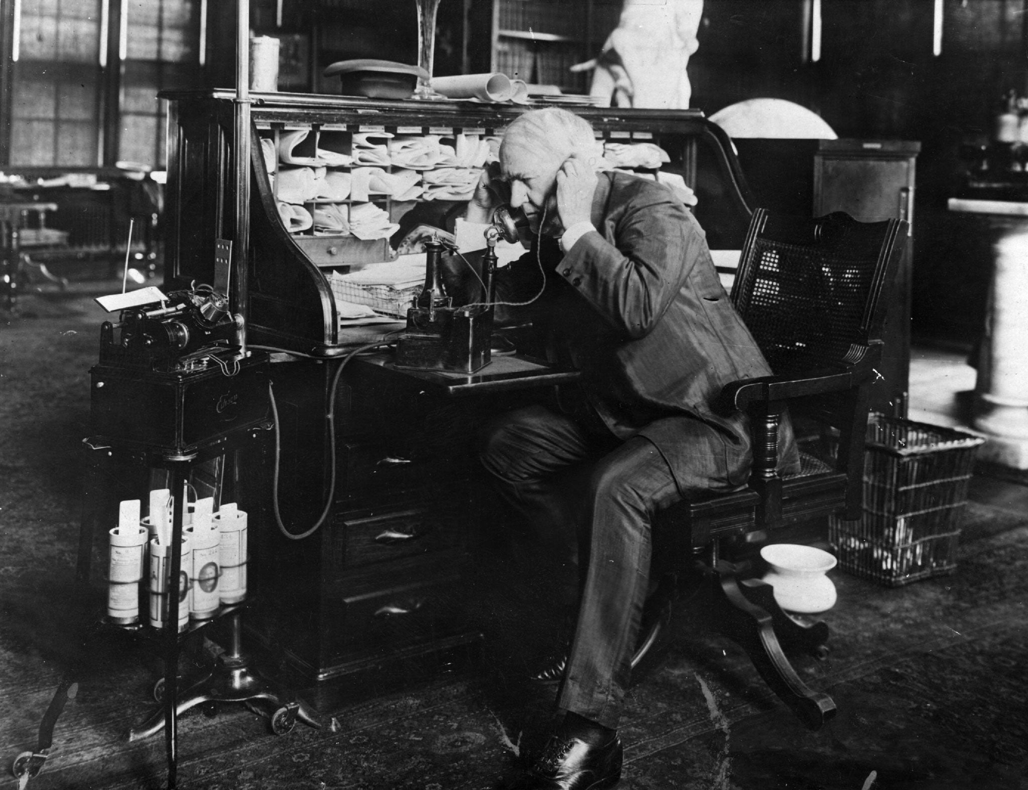 Thomas Edison dictating instructions to an employee on his Telescribe machine