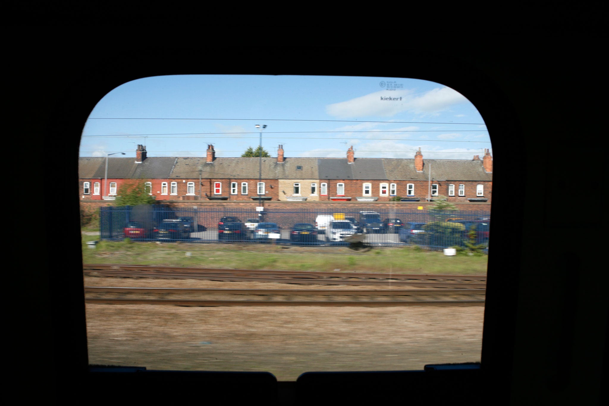 Terraced houses flash by on the train journey