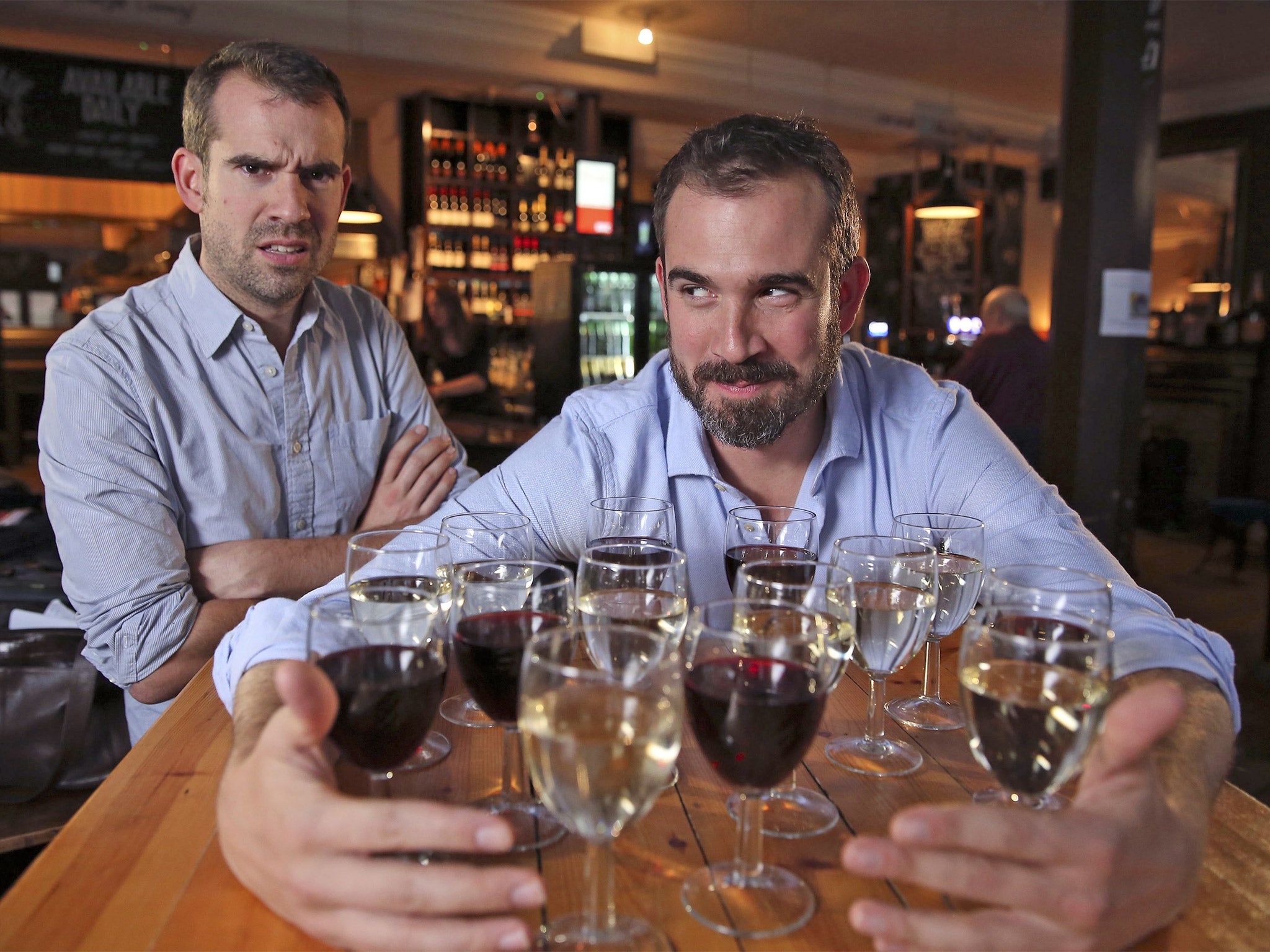 A glass act: Dr Chris van Tulleken (left) and twin Xand get set for their drinking challenge