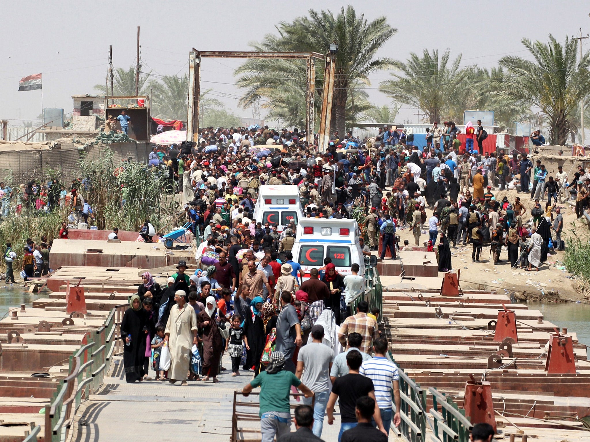 Residents of Ramadi who fled their homes wait to cross Bzeibez bridge, on the southwestern frontier of Baghdad (Getty)