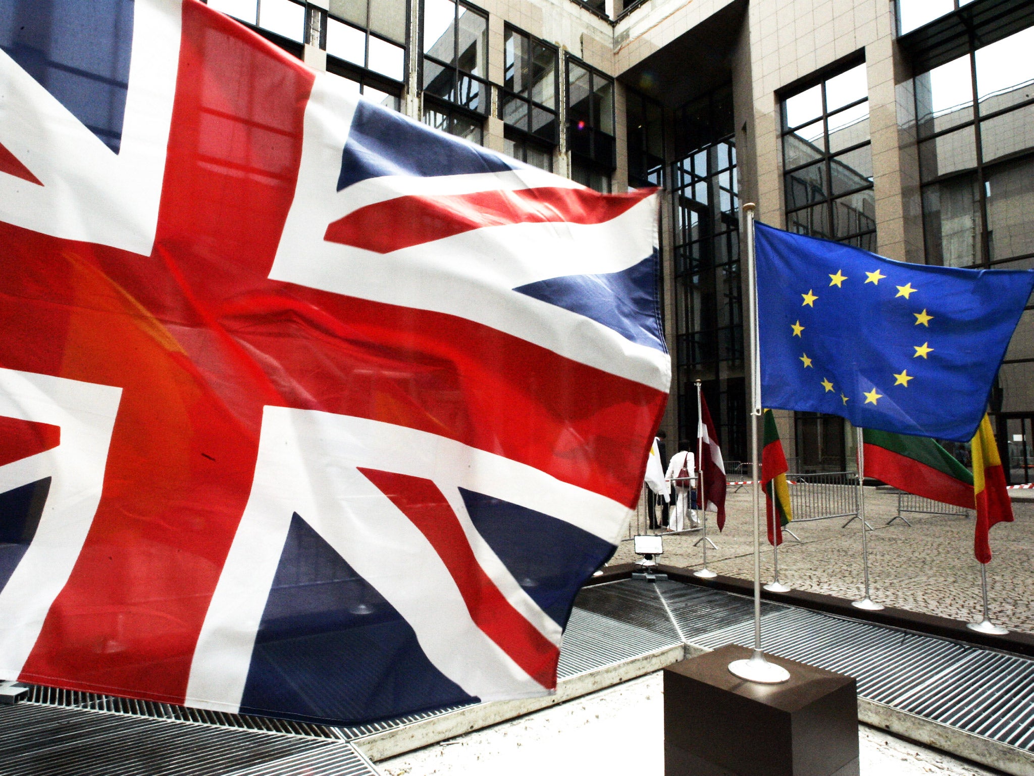 The European Union flag and the Union Jack hang outside the EU's headquarters in Brussels