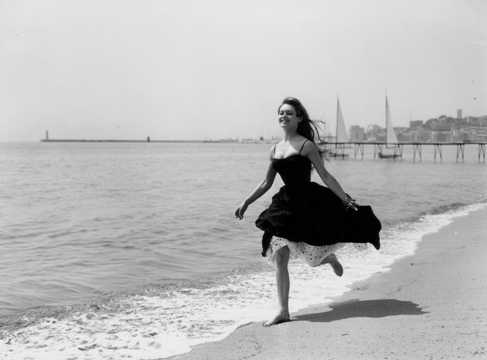 Actress Brigitte Bardot running barefoot along the beach, Cannes, France, April 28th 1956