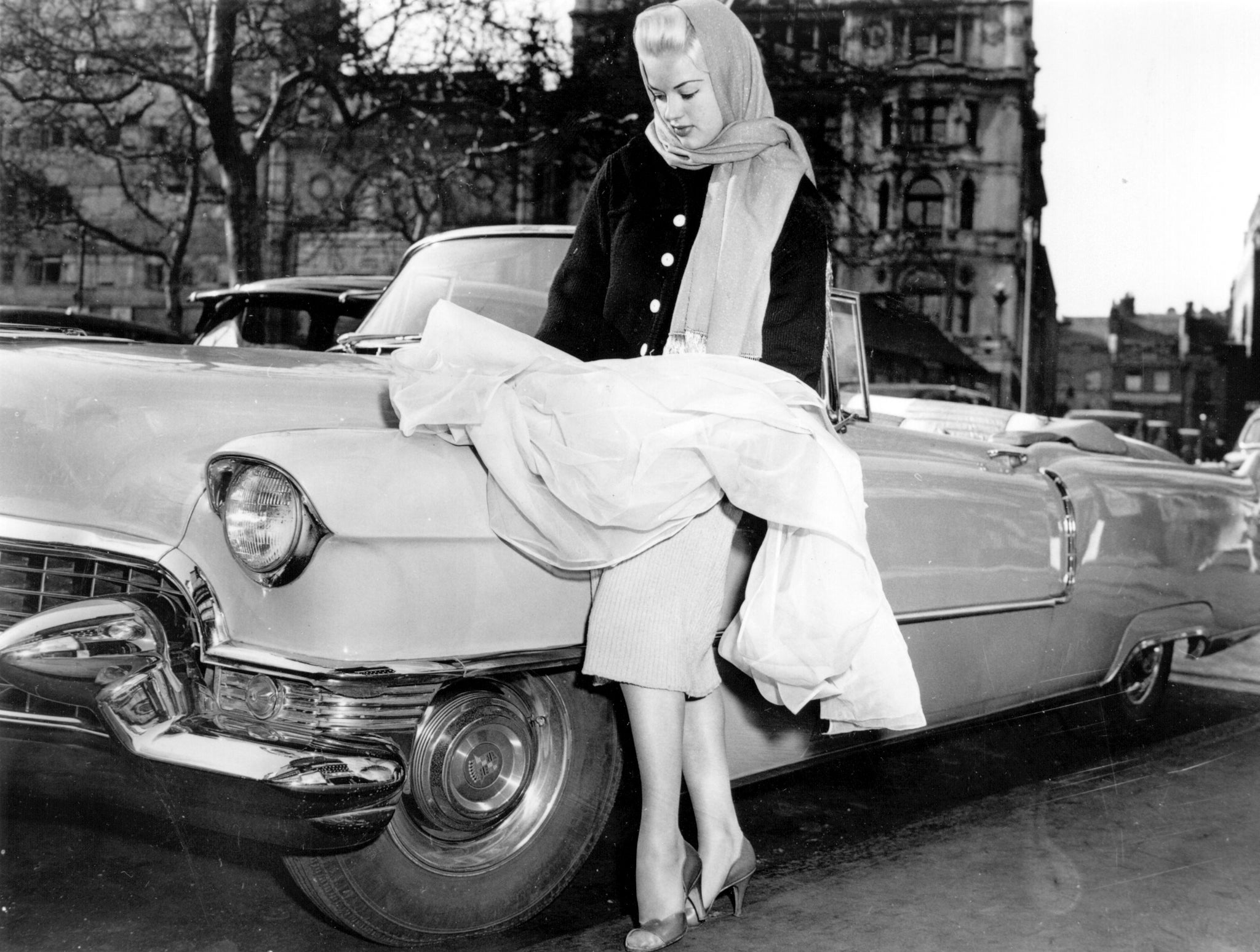 Diana Dors, the starlet, with the Cadillac in which she arrived at the Cannes Film Festival