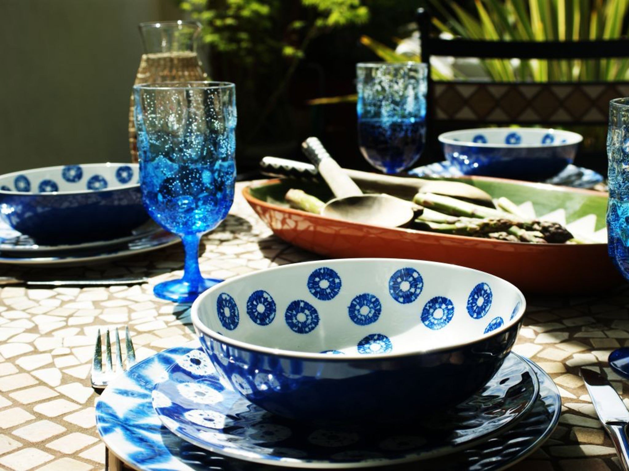 The blue and white Indigo range from M&S, with matching wine goblets and the green and terracotta Alvito serving platter from Habitat.
