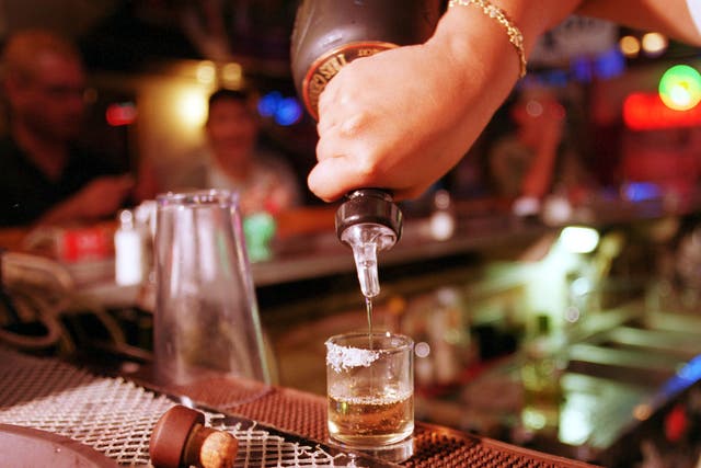 High spirits: A barman pours a shot of tequila