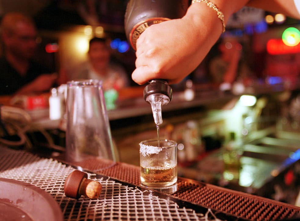 High spirits: A barman pours a shot of tequila