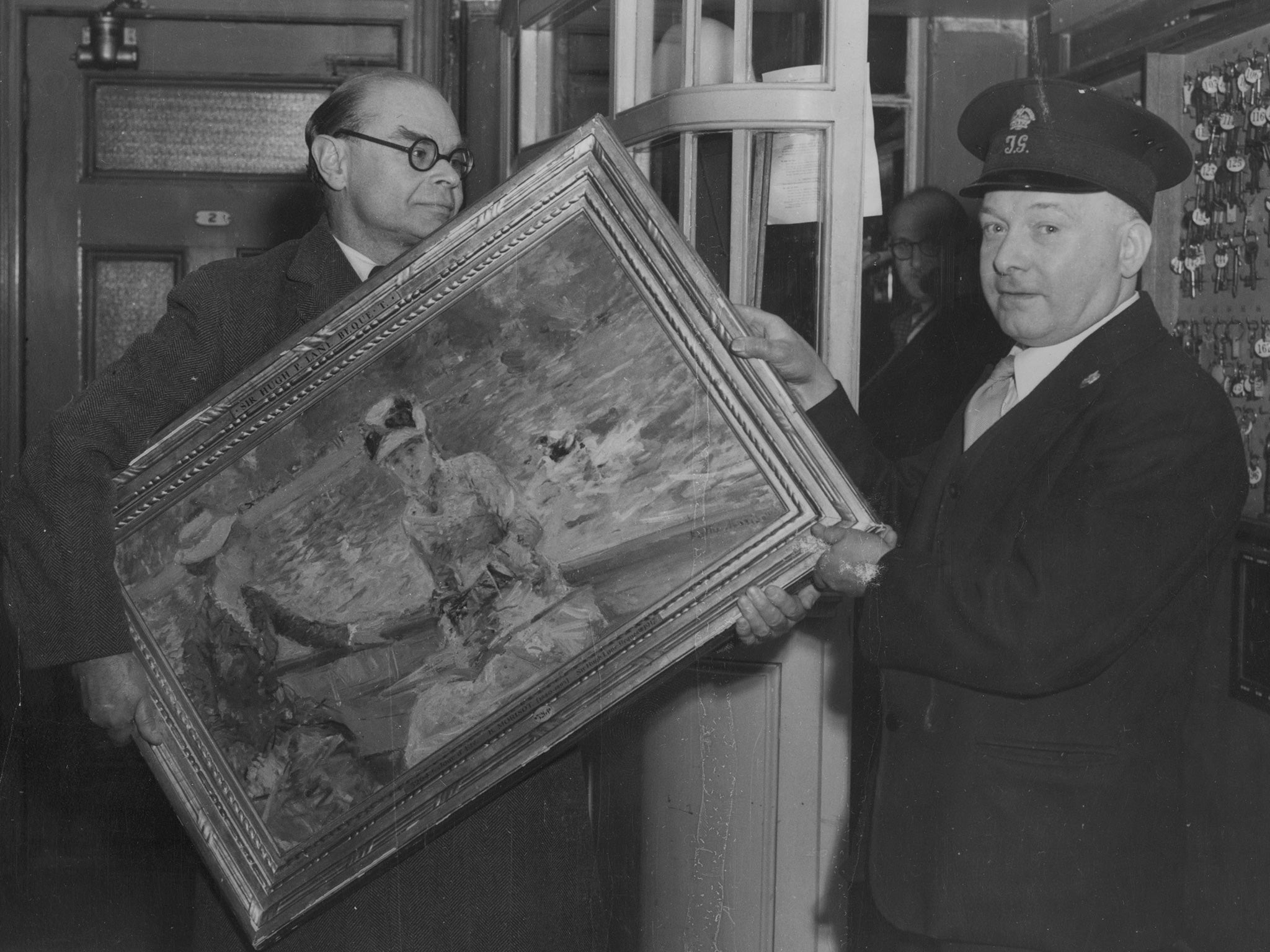 Sir John Rothenstein carries the painting 'Jour d'Ete' into the Tate after it was handed into the Irish embassy