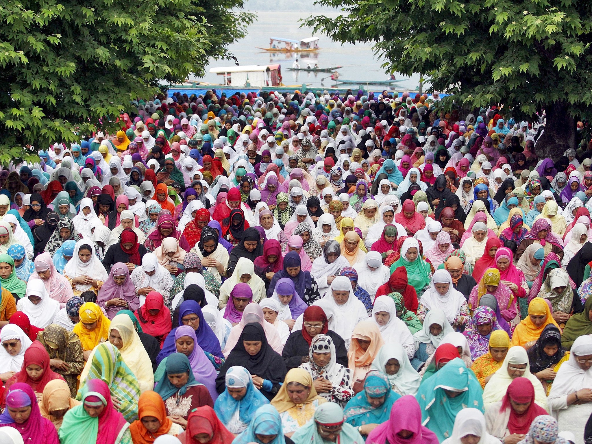 Kashmiri Muslim women pray together outdoors