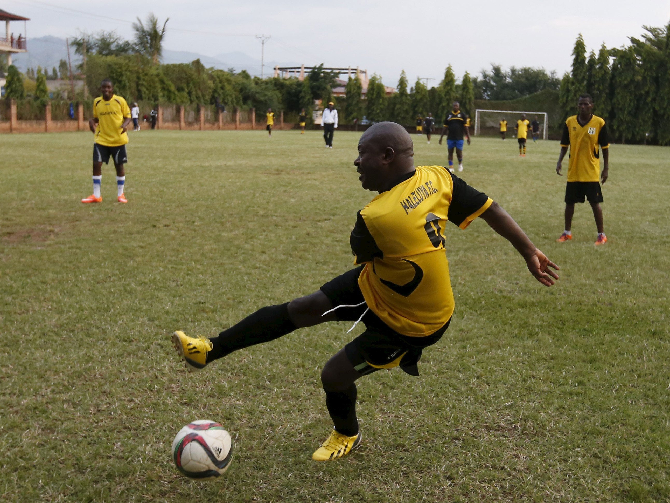 Burundi's President Pierre Nkurunziza kicks the ball during a soccer game