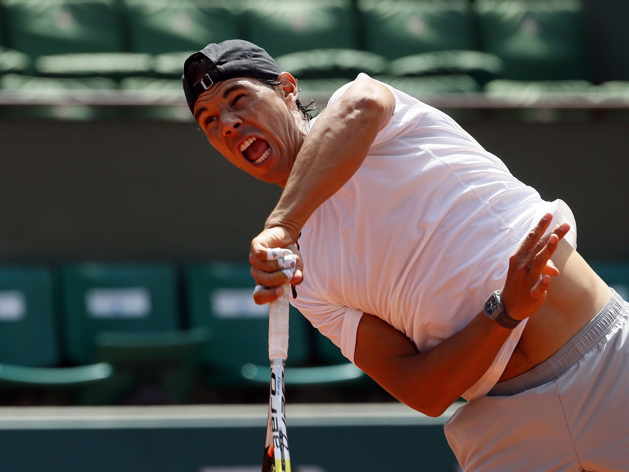 Rafael Nadal serves during a practice session at Roland Garros