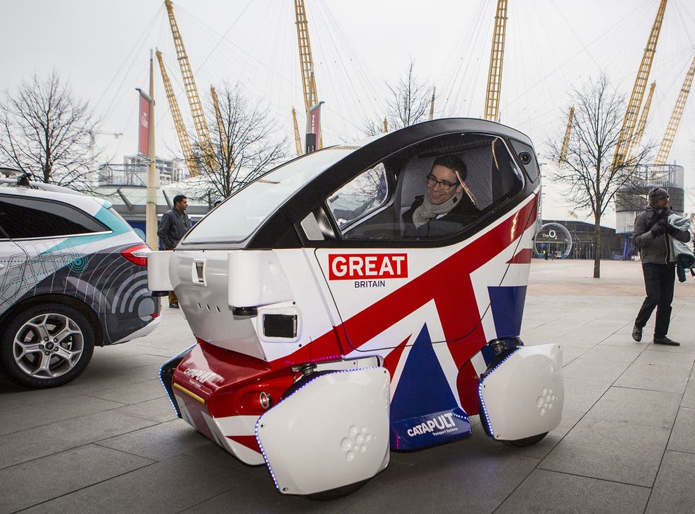 A driverless vehicle known as a Lutz 'Pathfinder' Pod is demonstrated in London