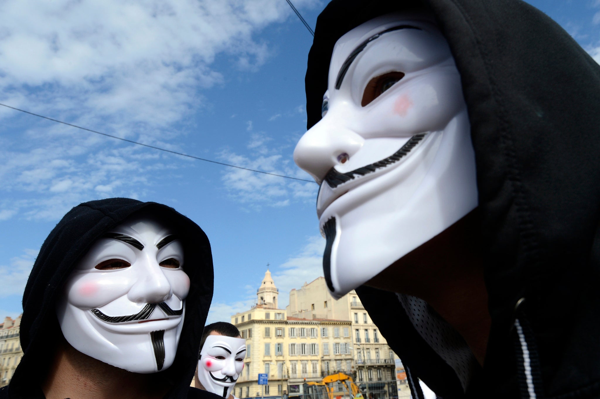 Protesters wearing Guy Fawkes masks take part in a march of the 'Anonymous' movement