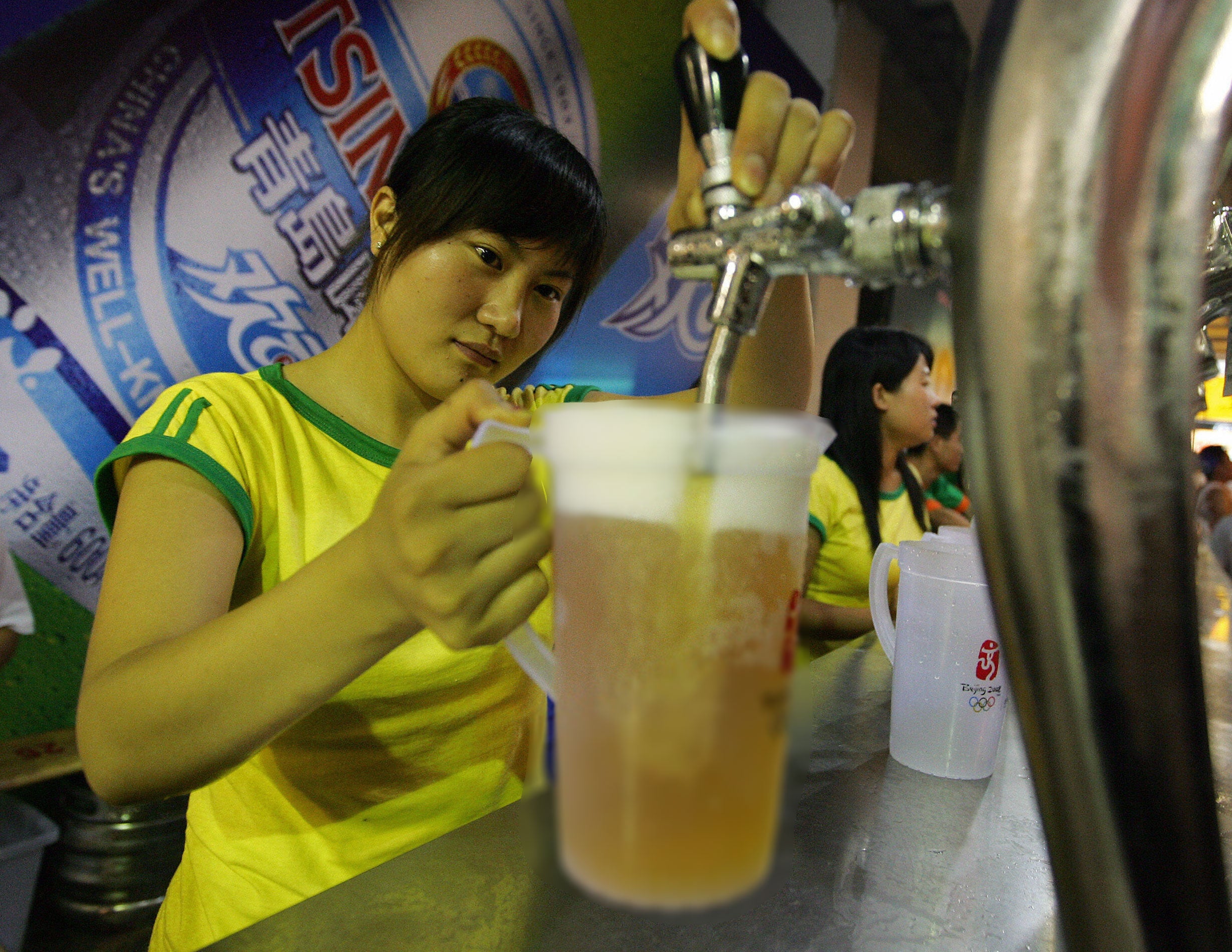 A bartender fills a pitcher of beer at a beer garden in Qingdao, 24 August 2007, in eastern China's Shandong province during the traditional Beer Festival month in the hometown of China's most famous beer, Tsingtao.