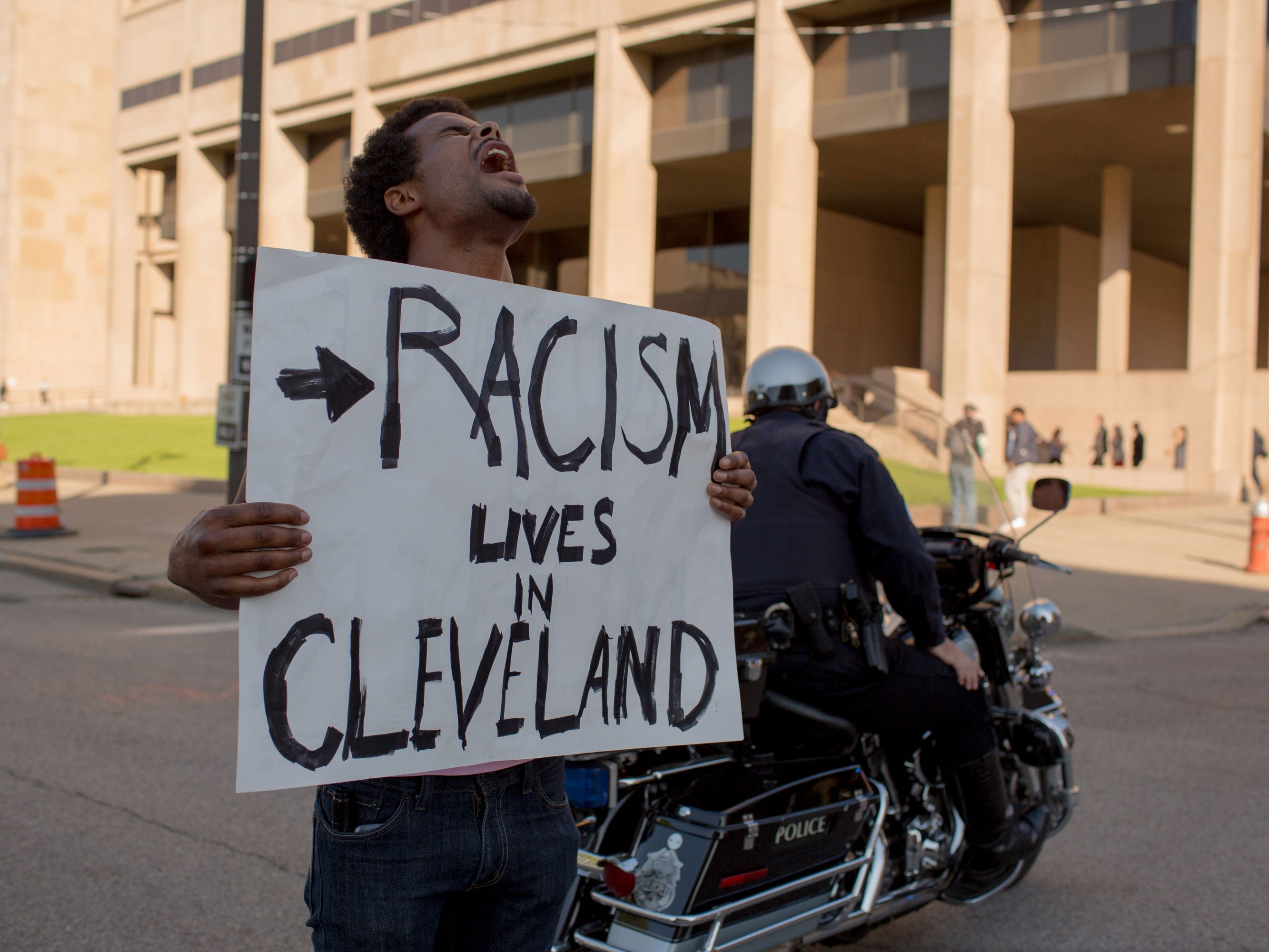 Tanis Quach, of Cleveland, protests in front of the Justice Building in Cleveland, Ohio, against the acquittal of Michael Brelo