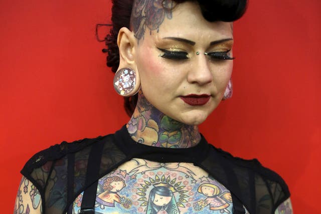 Model Aima Indigo poses for a portrait during the Great British Tattoo Show in Alexandra Palace