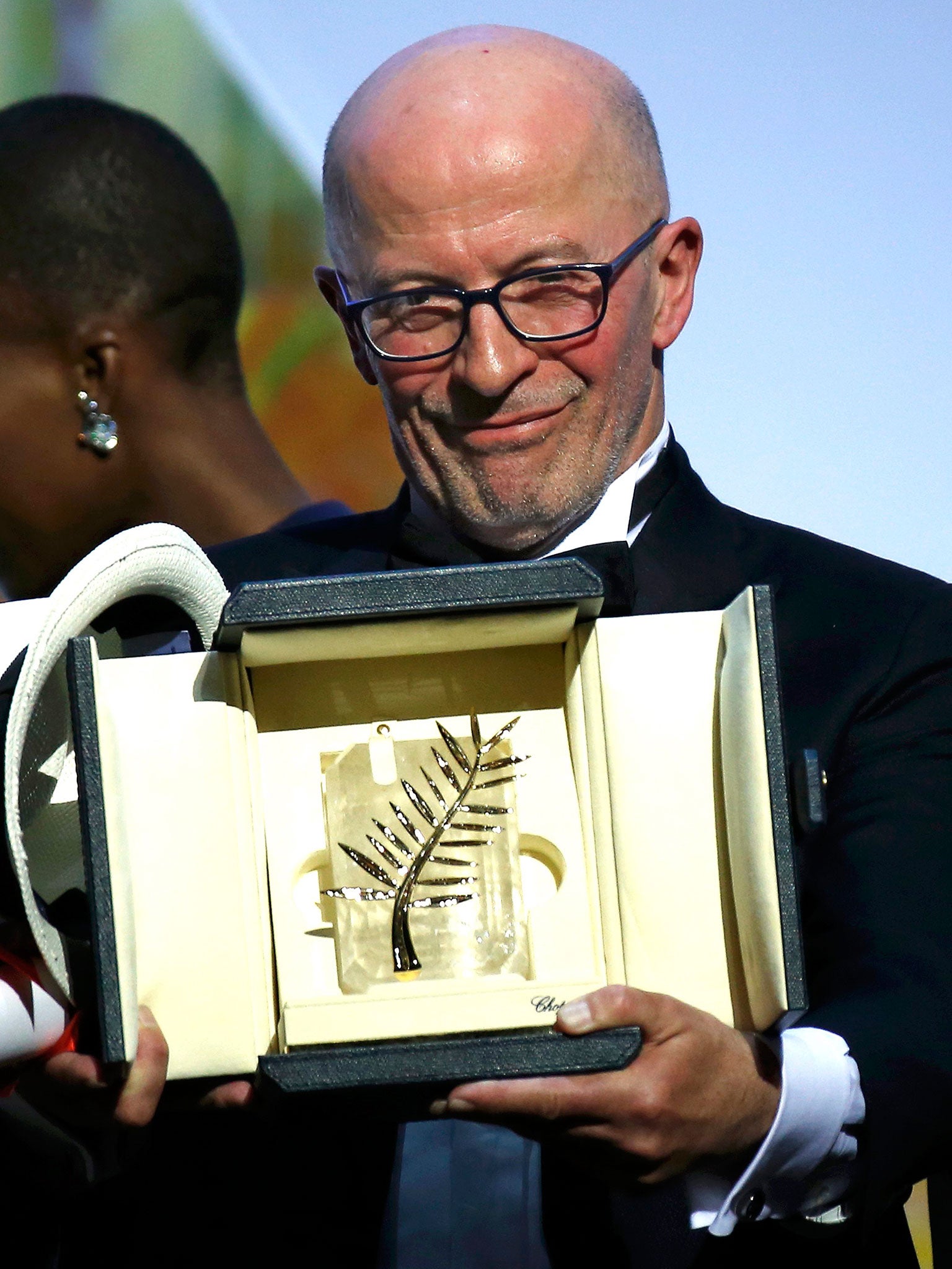 Director Jacques Audiard, Palme d'Or award winner for his film 'Dheepan', poses on stage during the closing ceremony of the 68th Cannes Film Festival