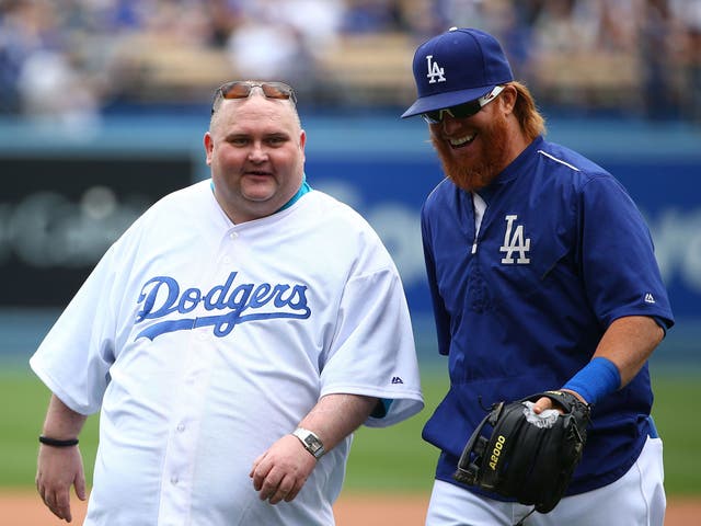  Sean O'Brien, aka Dancing Man, and Justin Turner #10 of the Los Angeles Dodgers walk back to home plate after posing for a photo