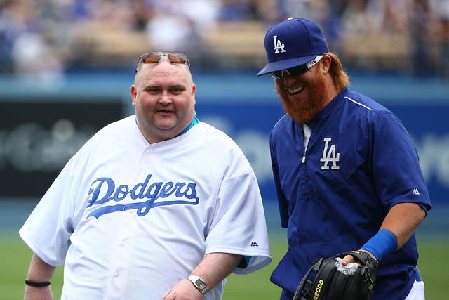  Sean O'Brien, aka Dancing Man, and Justin Turner #10 of the Los Angeles Dodgers walk back to home plate after posing for a photo