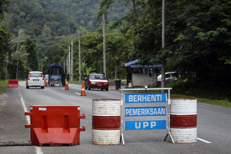 A check point is seen at the entry point to Malaysia - Thailand border in Wang Kelian, Malaysia. On Sunday, authorities found human remains in several abandoned plots across the Thai border 