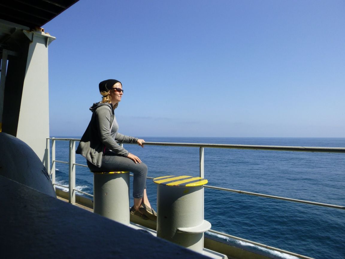 The freight escape: Sarah Royal watching the waves as she crosses the Pacific on a cargo vessel bound for Asia