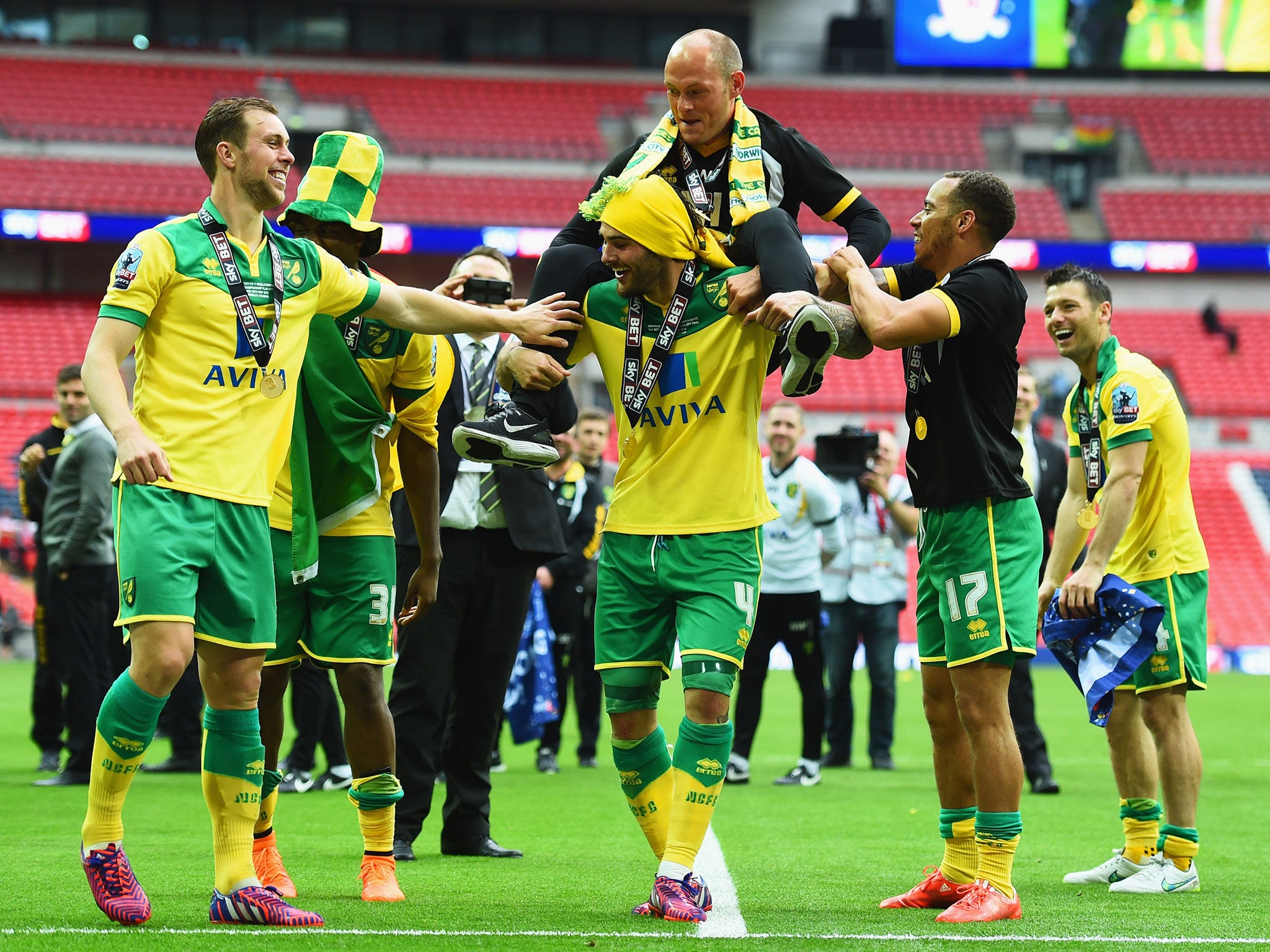 Manager Alex Neil is held aloft by his players after the match