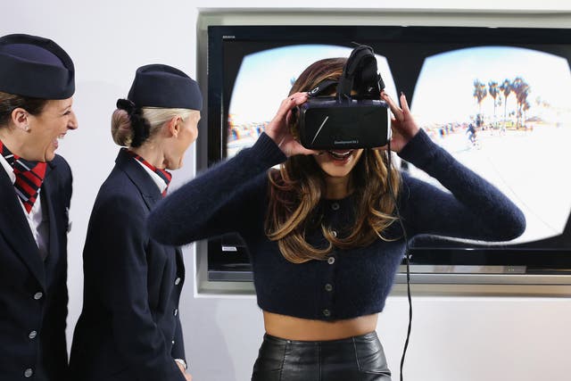 In this handout image provided by British Airways, Nicole Scherzinger tries on an Oculus Rift headset, that British Airways will use as a virtual reality technology to bring to life some of the most iconic US destinations for European customers