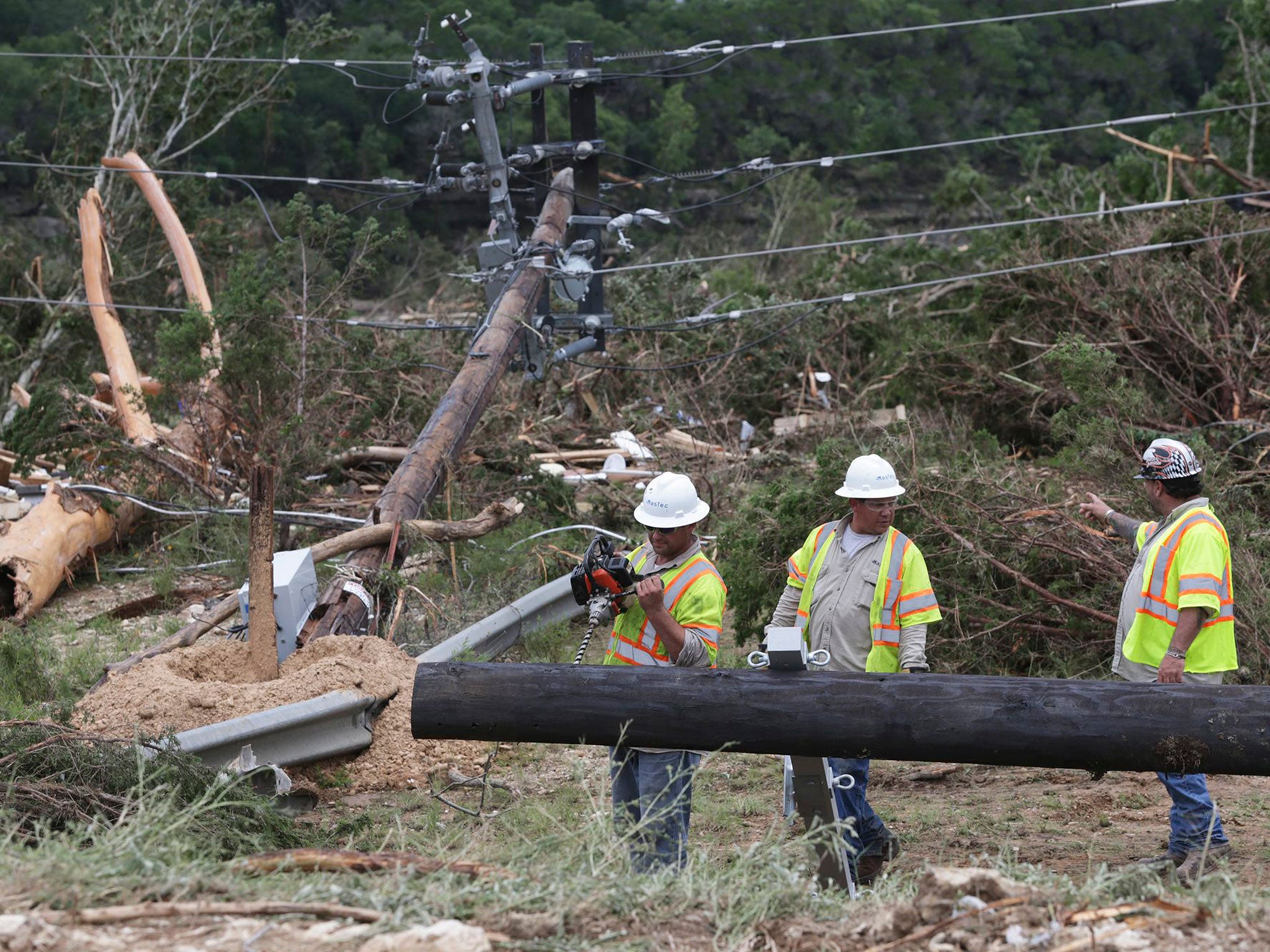 Crews work to restore a power line in Wimberley after May's floods