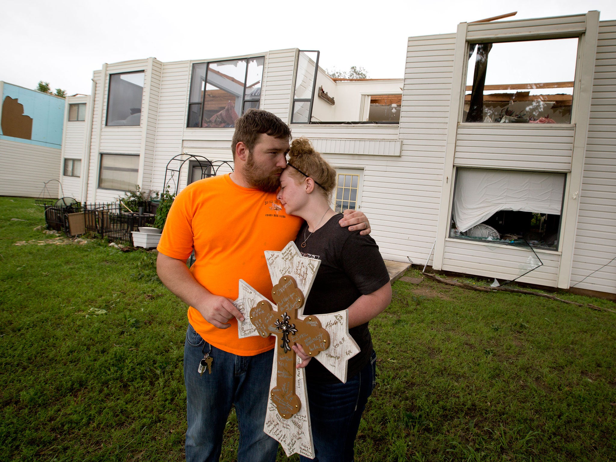 Newlyweds Brad and Brandy Snodgrass console each other as they survey the damage to their second floor apartment