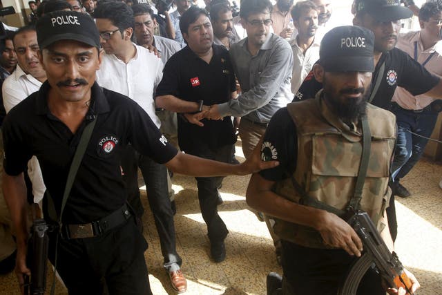 Shoaib Ahmed Shaikh, centre, was arrested in Karachi