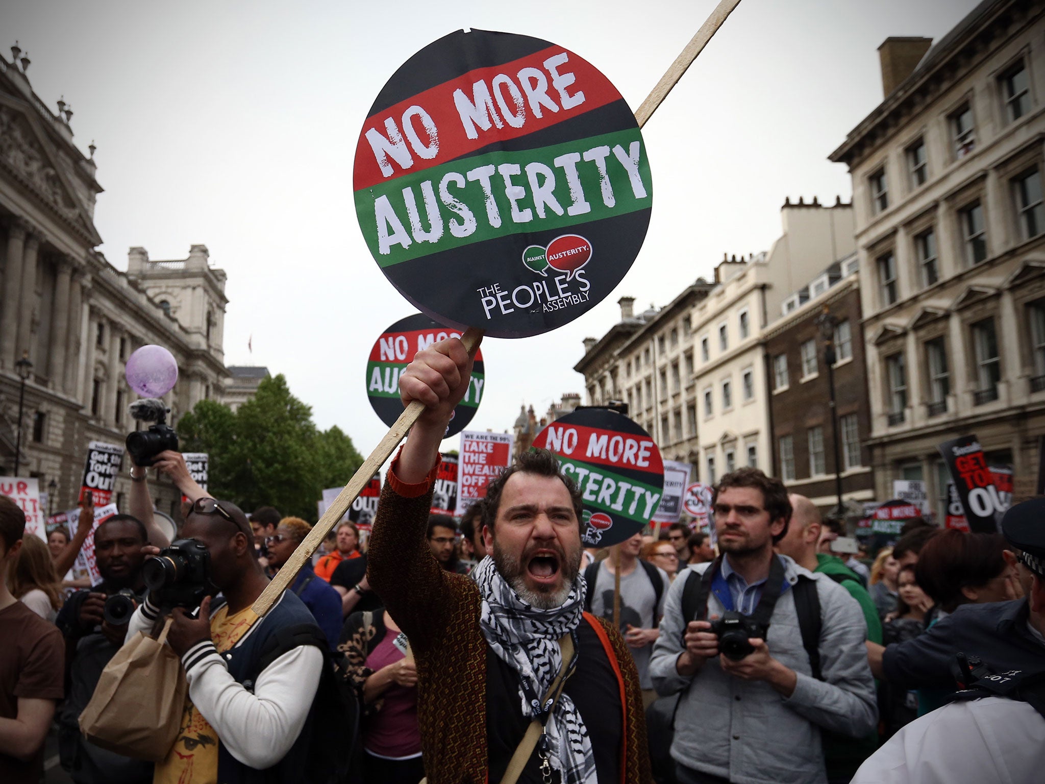 Demonstrators take part in an anti-austerity protest organised by The People's Assembly