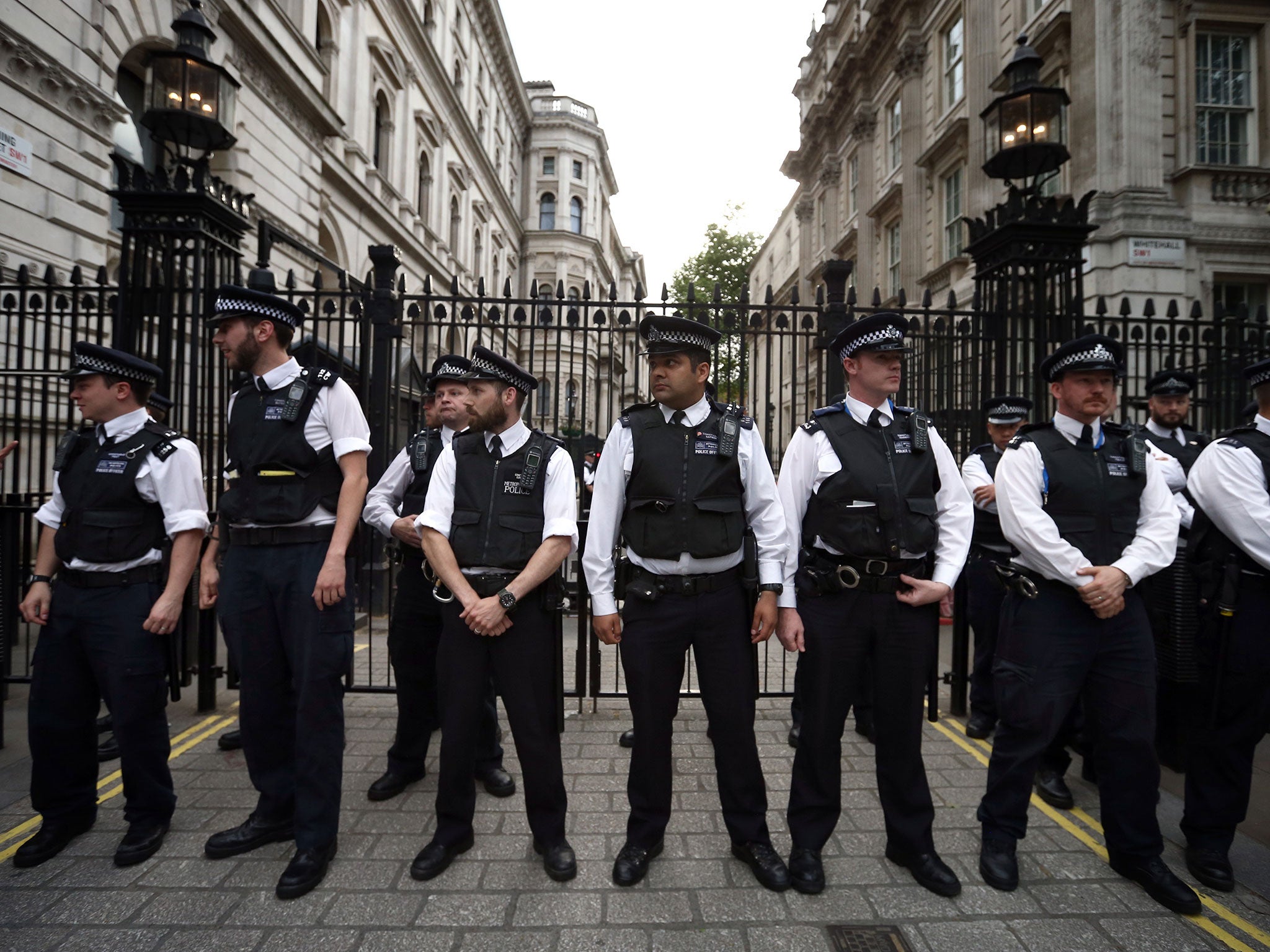 Police officers guard Downing Street during an anti-austerity protest